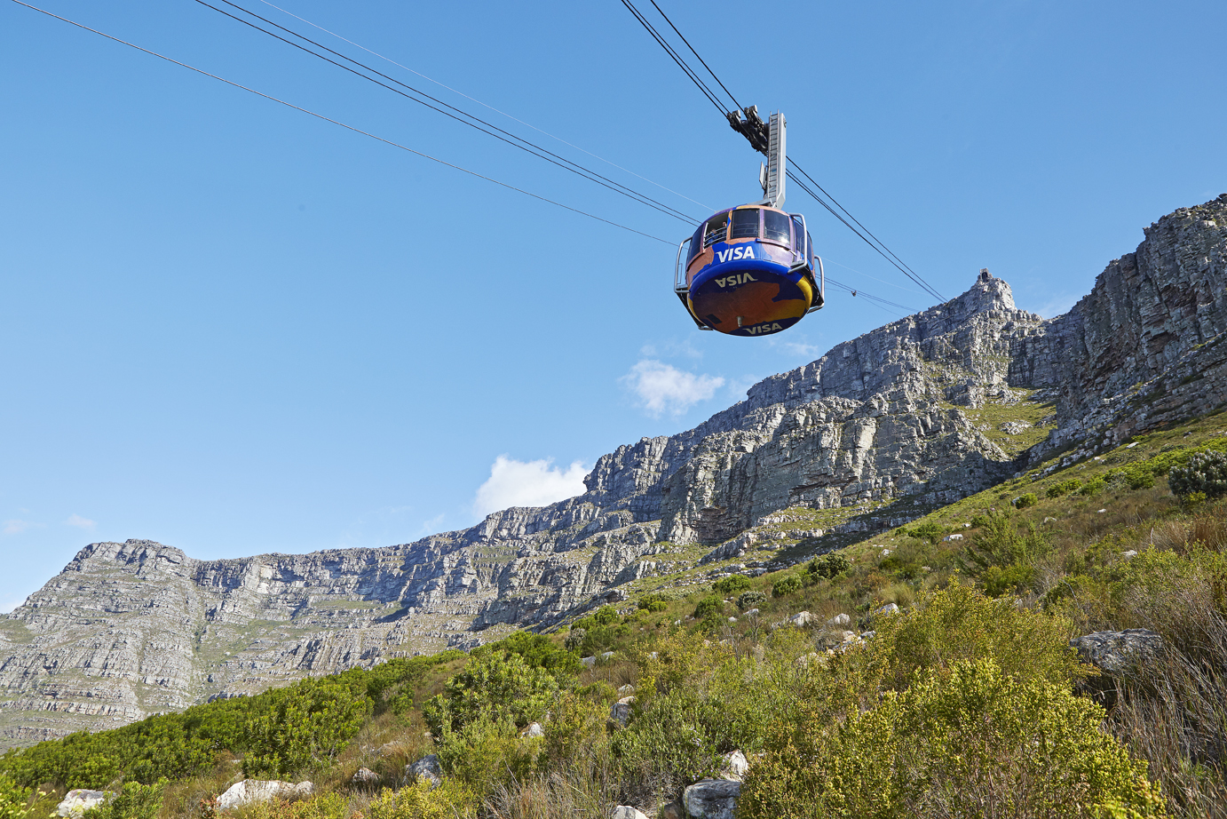 The Table Mountain Aerial Cableway car ascending the cliff face above Cape Town